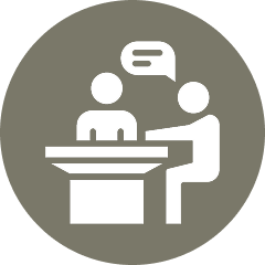 Two figures talking at a table icon.